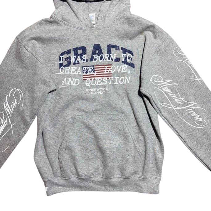 Grey pullover hoodie with Grace flag chest graphic and Memento Mori / Memento Vivere sleeve script