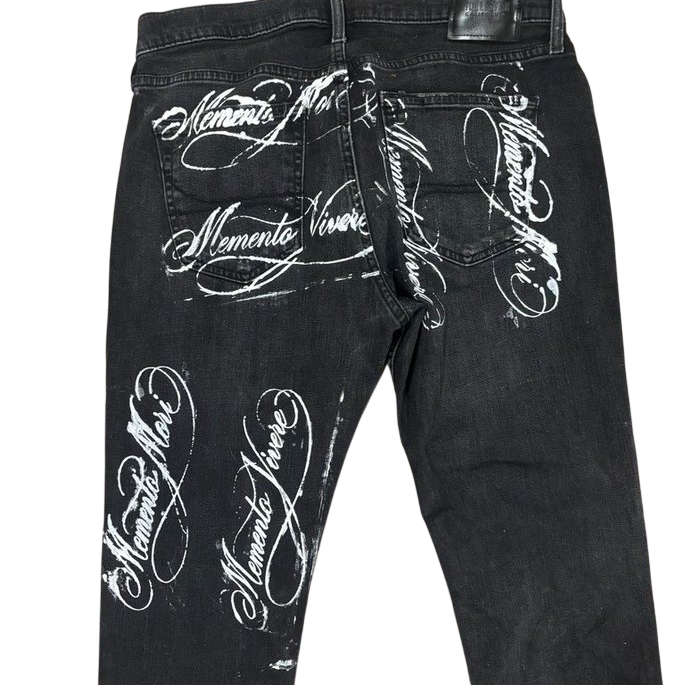 Black denim with Memento Mori and Memento Vivere calligraphy across back pockets and thighs